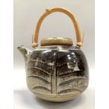 Peter Sparrey British (b1967) A Studio pottery teapot, tenmoku and chun glaze, wicker handle,