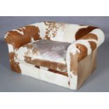 A Cowhide upholstered double armchair, 148cm wide x 120cm deep. PLEASE NOTE The items of furniture