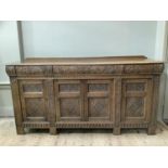 20th century oak sideboard, the front heavily carved in relief with acanthus leaf scrolling,