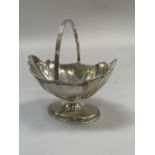 Edward VII silver basket with swing handle on pedestal foot by Thomas Bradbury and Sons, London.