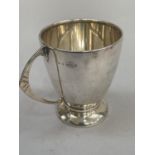 A silver Art Deco christening mug, Birmingham 1955, circular outline with incised C handle,
