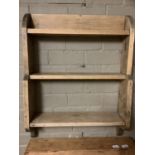 A set of three pine hanging shelves with bracketed ends