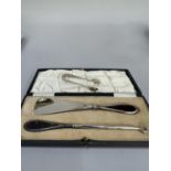 A George V pair of silver and tortoiseshell handled shoe horn and button hook by Walker and Hall,