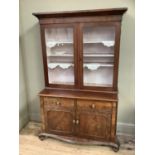 A Victorian mahogany bookcase with associated cupboard base, with two glazed doors, two drawers over