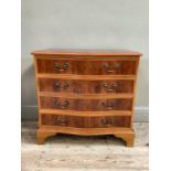 A reproduction yew wood serpentine chest of four drawers on bracket feet, 73cm wide