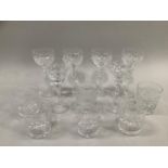 Suite of six hock glasses with cut glass bowls and knopped stems together with a suite of six cut