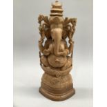A carved hard wood figure of Ganesh on a lotus throne, 36cm high
