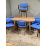 A mid century G Plan teak extending dining table with four teak dining chairs and two carvers