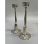 A pair of Elizabeth II silver candle sticks, Birmingham 1966 for Turner and Simpson, stepped and