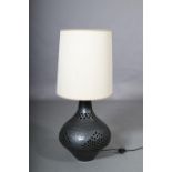 Mattu, A black glaze earthenware table lamp, c1960/70s, of compressed circular form with pierced