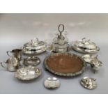 Silver plated on copper tray with heavily moulded edge on three feet, cruet set, milk jug, another