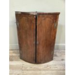 A George III mahogany corner cupboard with ebony string inlay, brass H hinges, brass escutcheons,