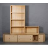 A Hulsta pale wood modular wall unit, including a pair of low set single door corner cupboards, a