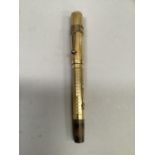 A vintage Watermans Ideal fountain pen, 14ct gold nib, engine turned gilt with fruitwood end,