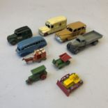 A collection of nine die cast models including a Dinky 27F Estate Car, a Dinky Daimler Ambulance,