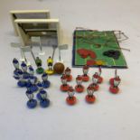 An early edition of Subbuteo, including ten players for each side, two goal keepers and two wooden