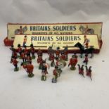 A collection of Britains lead soldiers, including the Grenadiers, the Scots Guards and two