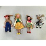 Four Vintage Pelham puppets, including a black and white cat, Tyrolean girl in yellow and orange
