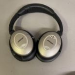 A pair of Bose Quiet Comfort QC2 headphones in a travelling case with adapter for wired