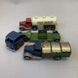 A collection of three Triang Minic clockwork commercial vehicles, including a Low Loader, a Minic