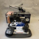 A four channel radio controlled helicopter, boxed, along with a radio controlled hovercraft.