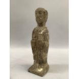 Carved stone figure of a man holding religious symbols, 15cm high