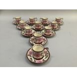 A set of twelve Old Castle pink lustre coffee cans and saucers painted with sprays of flowers
