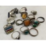 A collection of fifteen silver rings variously set with enamel, amethyst, amber, tiger eye and