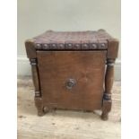 An oak slipper box stool with ring pull handle and top of interwoven leather studded to the side