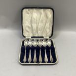 A boxed set of six early to mid 20th century Danish silver teaspoons with planished handles in