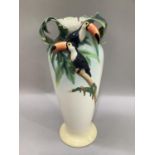 A Franz china vase of tapered form the neck moulded as leafage with toucans in high relief to the