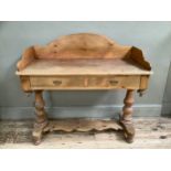 Stripped pine Victorian washstand with two draws with brass handles, carved back panel on turned