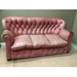 A vintage pink leather button back sofa, 179cm wide