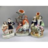 Three Staffordshire figure groups, comprising a man and a woman holding a violin, Little Red