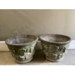 A pair of cast garden planters moulded to exterior with grape vines measuring 63cm by 45cm
