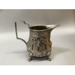 A continental 800 silver cream jug, lobed and fluted with ribboned swags on paw feet, 9cm total