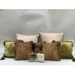 Five crushed velvet scatter cushions in greens, browns and orange with beaded decoration, two