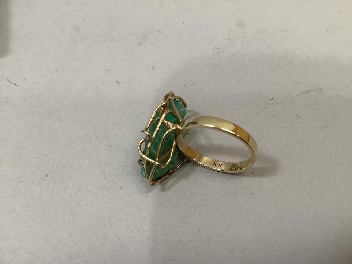 A dress ring c1980 claw set with a green Beryl crystal within a wire basket surround of yellow metal - Image 2 of 2