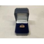 A George V gentleman's signet ring in 9ct rose gold, shield shaped with trifoil shoulders,