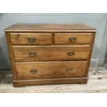 A pitch pine chest of two short above three long drawers with moulded brass handles on bracket feet,