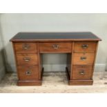A Victorian mahogany knee hole clerks desk, one long above six short drawers on pediment base, inset