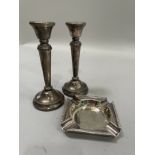 A pair of Elizabeth II silver candlesticks, tapered form with beaded edge and weighted circular