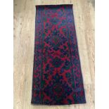 A small Turkey runner in deep red, blue and green of traditional design, 152cm by 61cm