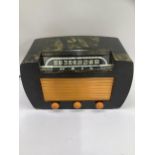 A reproduction Bakelite style short wave radio by Stuart Warner having a black and orange marbled