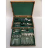 An oak canteen of Mappin and Webb silver plated cutlery in two tiers, green felt lining