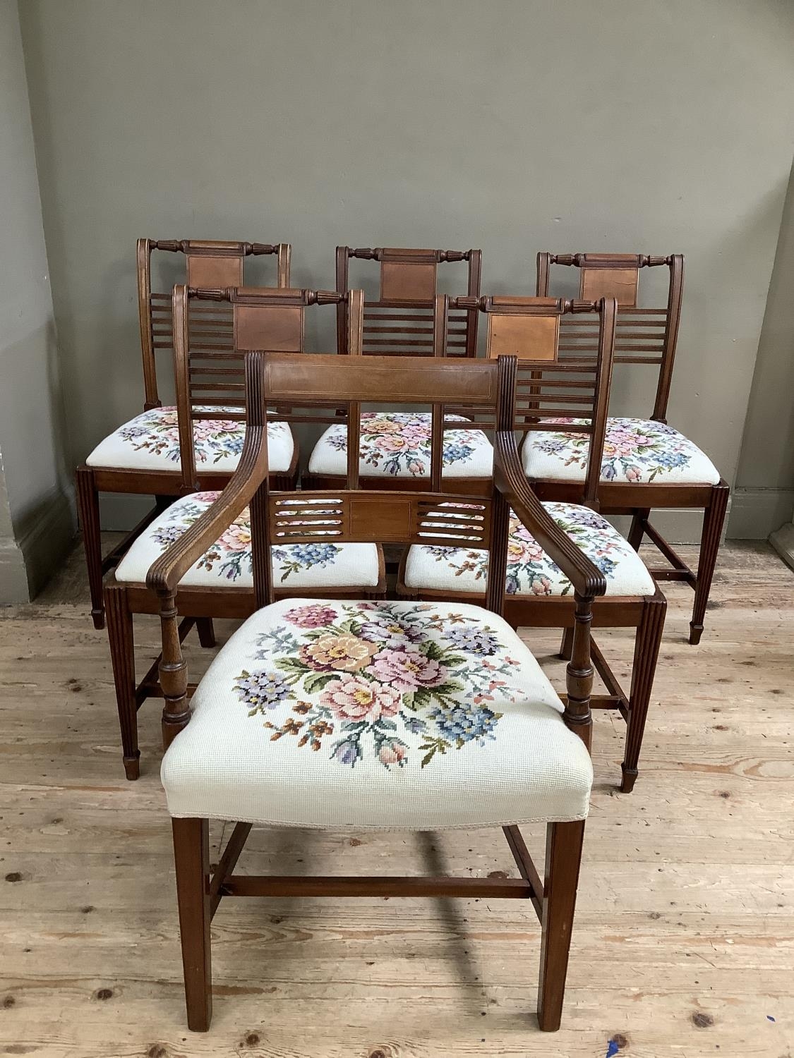 A set of five Regency style mahogany dining chairs with tapestry seats together with a carver