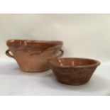 An early 20th century earthenware two handled bowl internally glazed, tapered form, with two loop