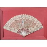 A 19th century lace fan with pierced and gilt decorated mother of pearl guards, the fan worked