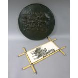 A bronze effect metal charger, circular outline and raised decoration with figures playing bowls