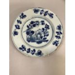 A Dutch delft pottery blue and white charger painted with bird among foliage, 31cm diameter